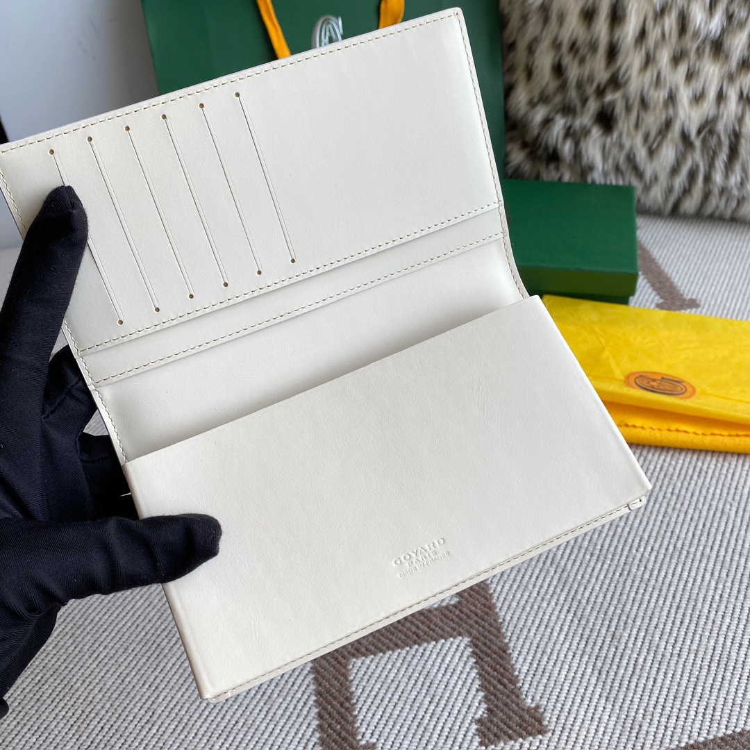 white Go*ard saint-lambert wallet is a universal phone case with all the everyday essentials in one