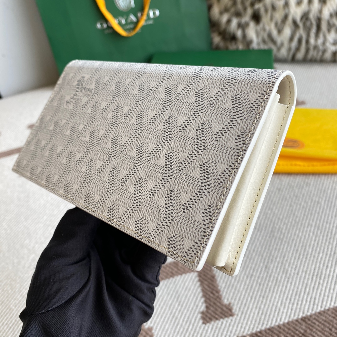 white Go*ard saint-lambert wallet is a universal phone case with all the everyday essentials in one