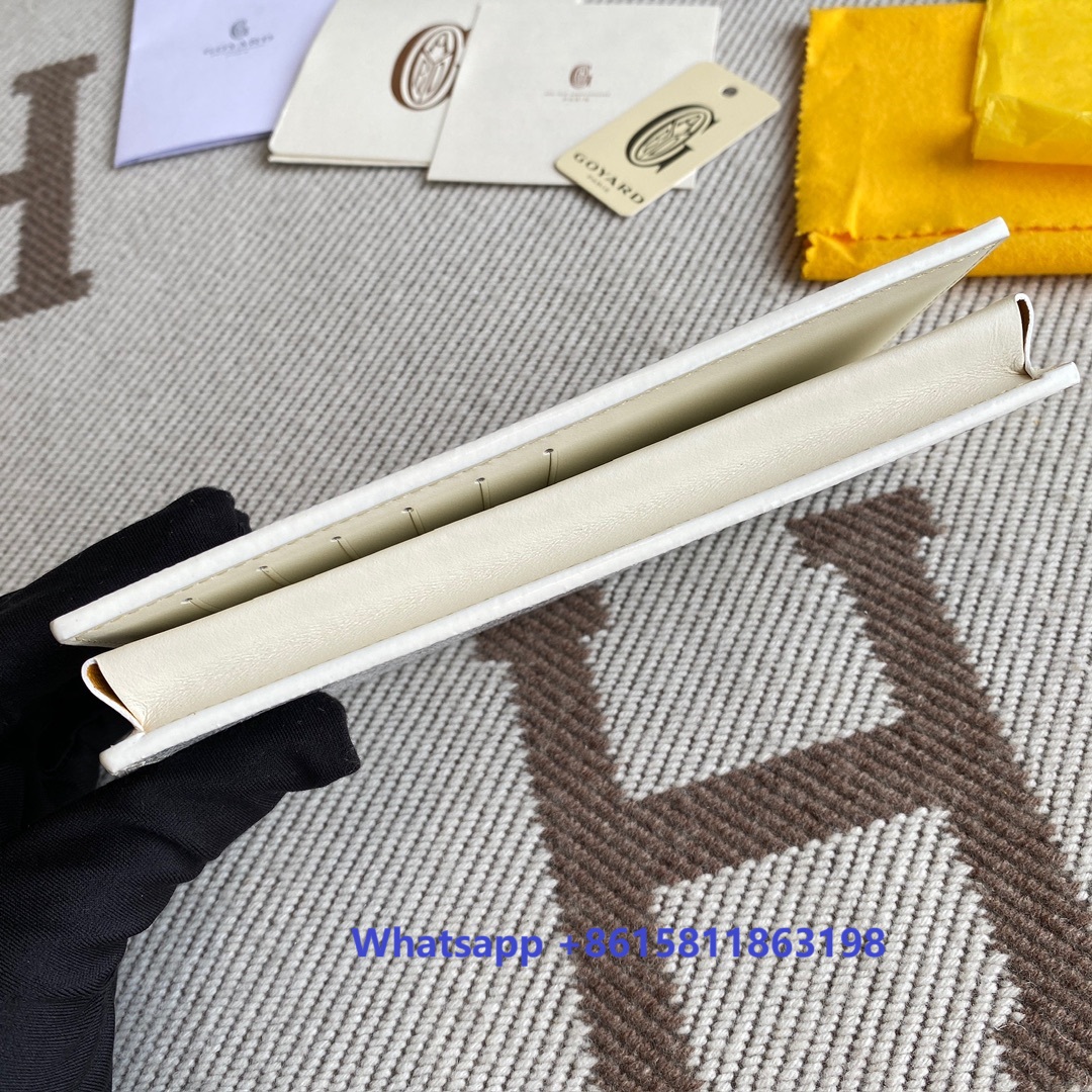 white Go*ard saint-lambert wallet is a universal phone case with all the everyday essentials in one