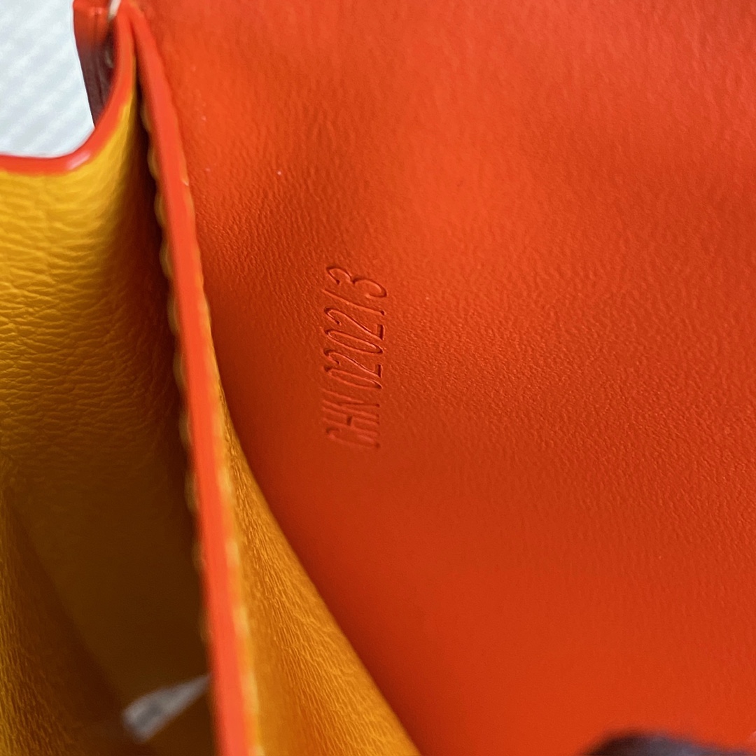 orange Go*ard saint-lambert wallet is a universal phone case with all the everyday essentials in one