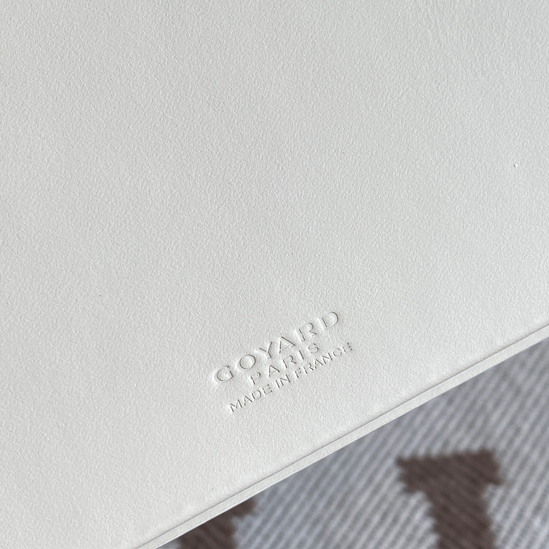 white Go*ard saint-lambert wallet is a universal phone case with all the everyday essentials in one